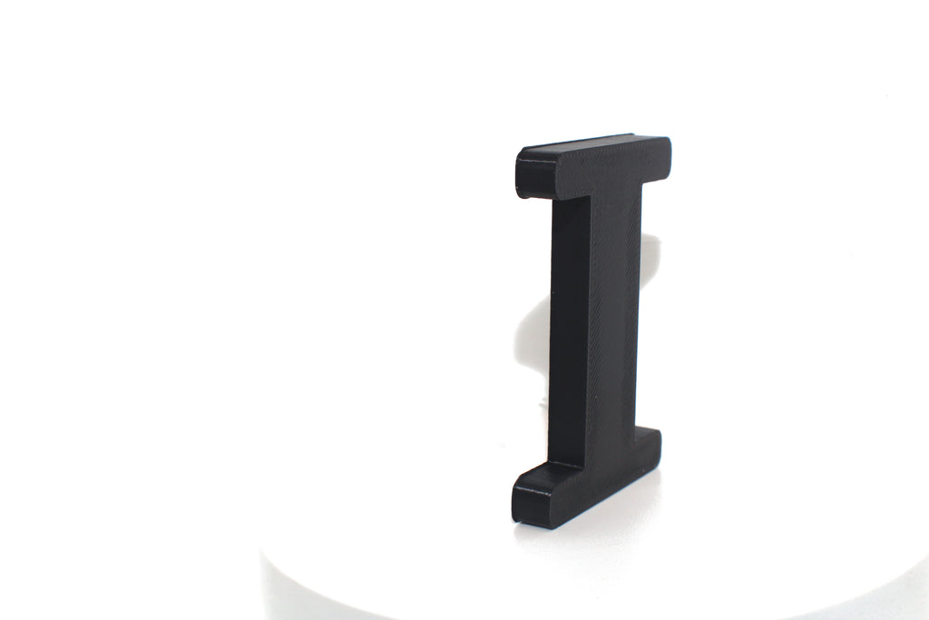 Black Eye large prop, matte black finish, standing on a white platform.