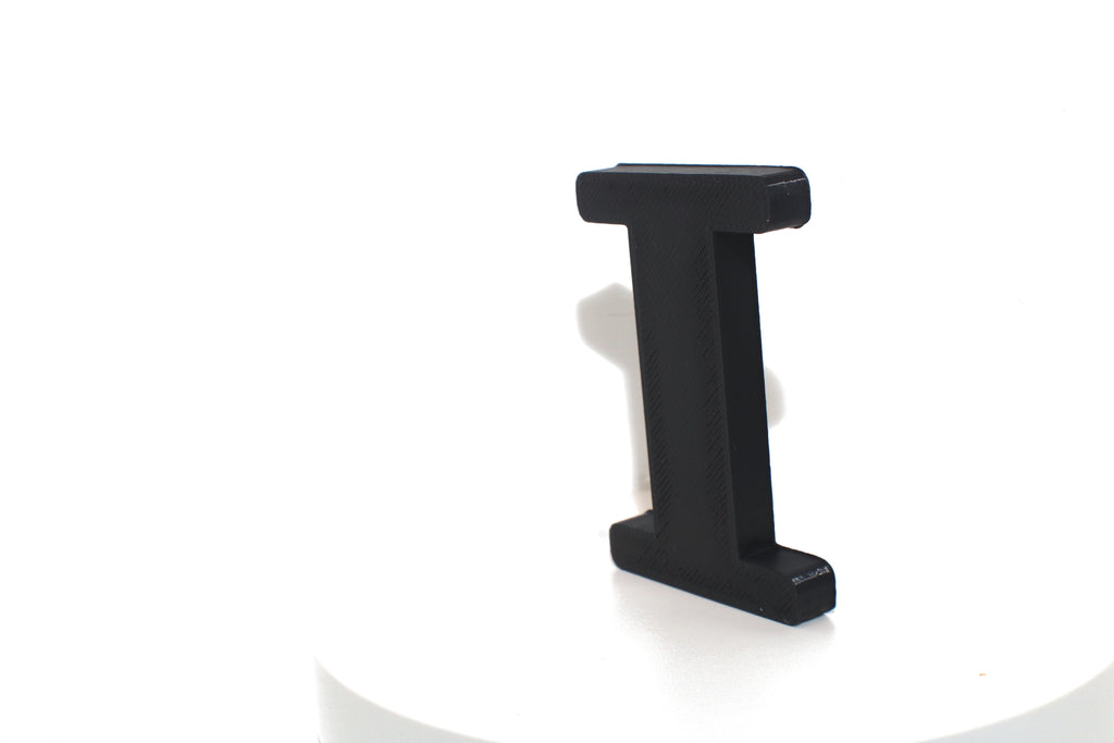 Black Eye large prop on a round white pedestal, straight-on front view.