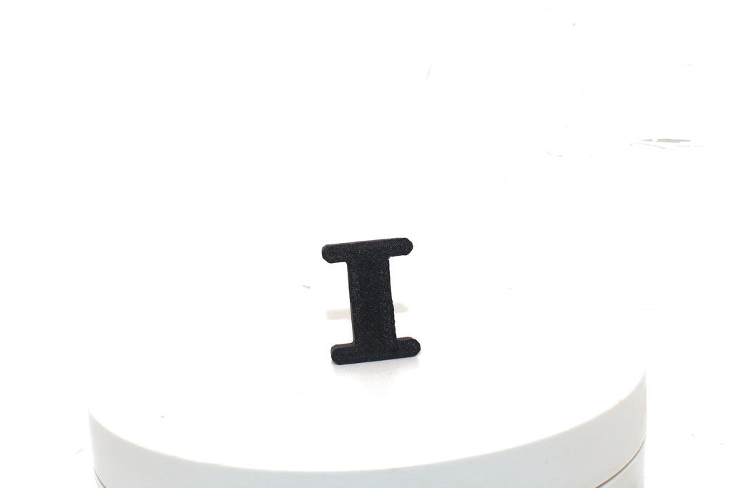 Black Eye small prop standing upright on a white display pedestal, front view.