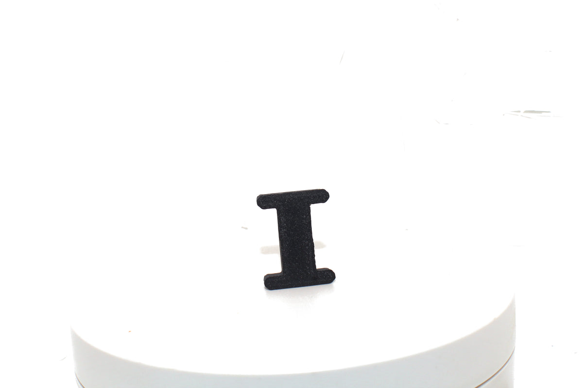 Black Eye small prop standing upright on a white display pedestal, front view.