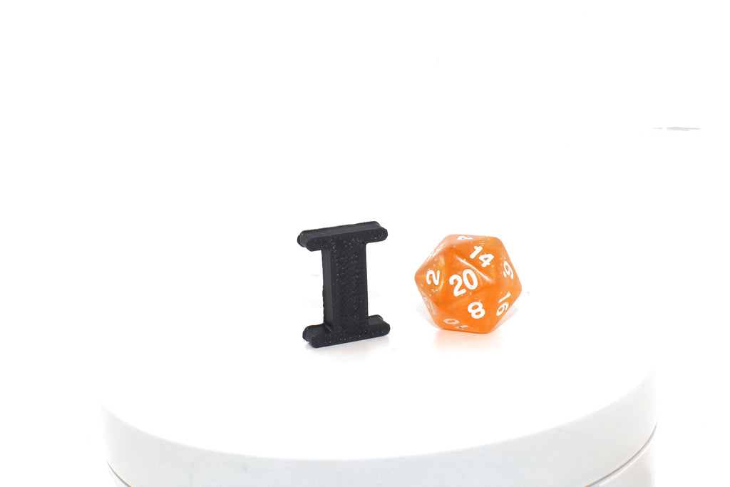 Black Eye small prop next to an orange d20 die for size comparison.