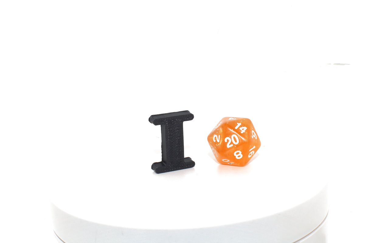 Black Eye small prop next to an orange d20 die for size comparison.