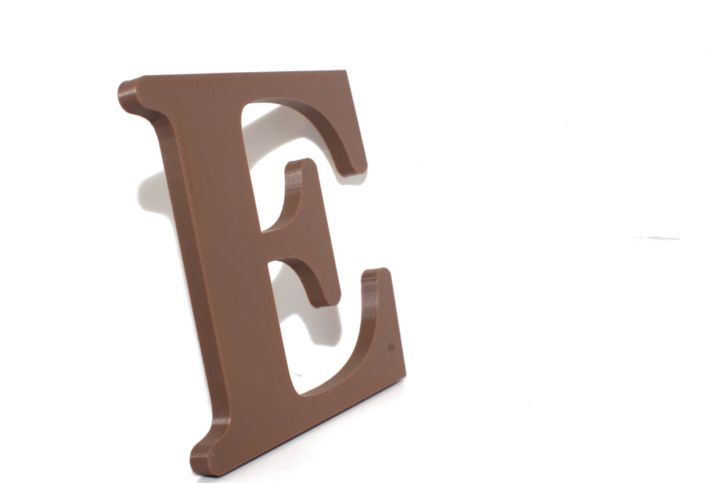 Brown E large prop standing upright with a soft shadow, front view.