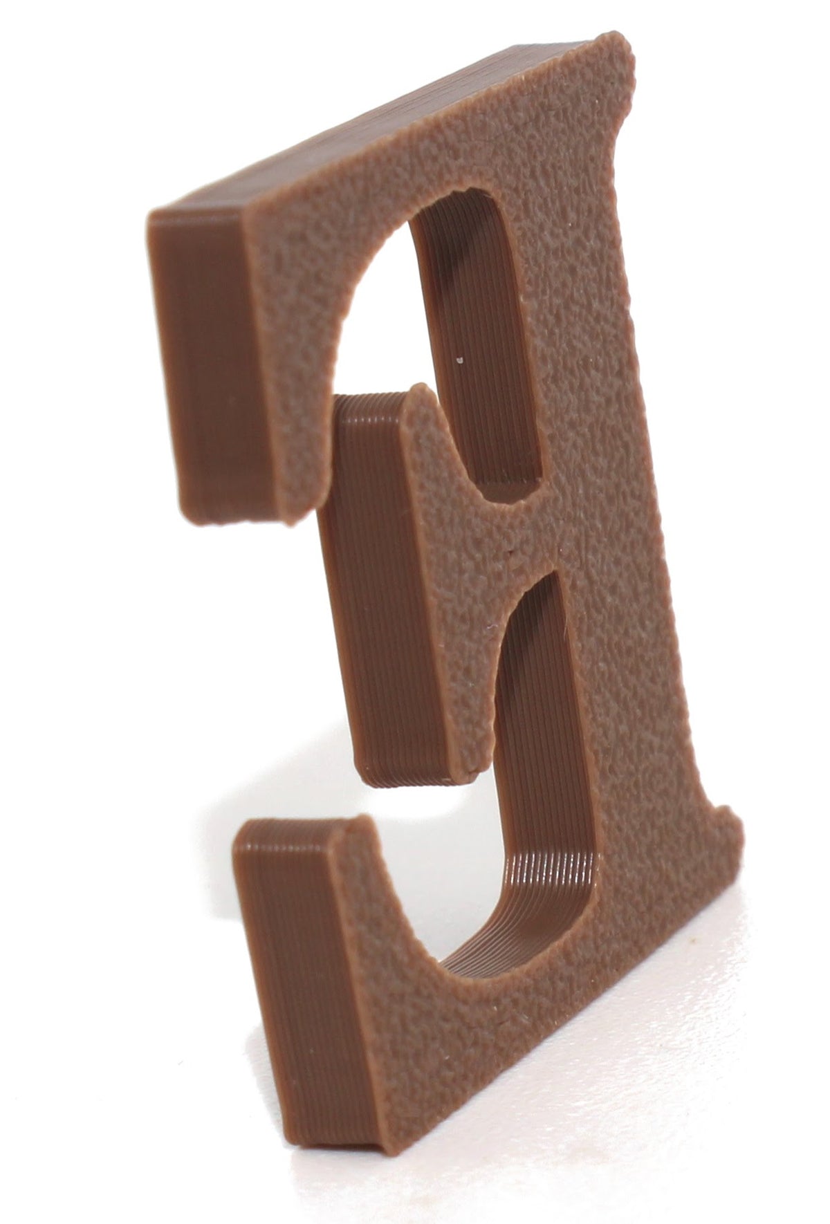 Brown E small prop at an angle, showing the textured 3D-printed finish.