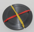 Jiffy Coin Trick prop, black 3D-printed coin holder shown with its retaining bands.