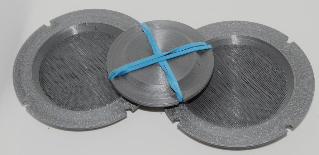 Jiffy Coin Trick parts laid out, gray 3D-printed pieces with a blue band.
