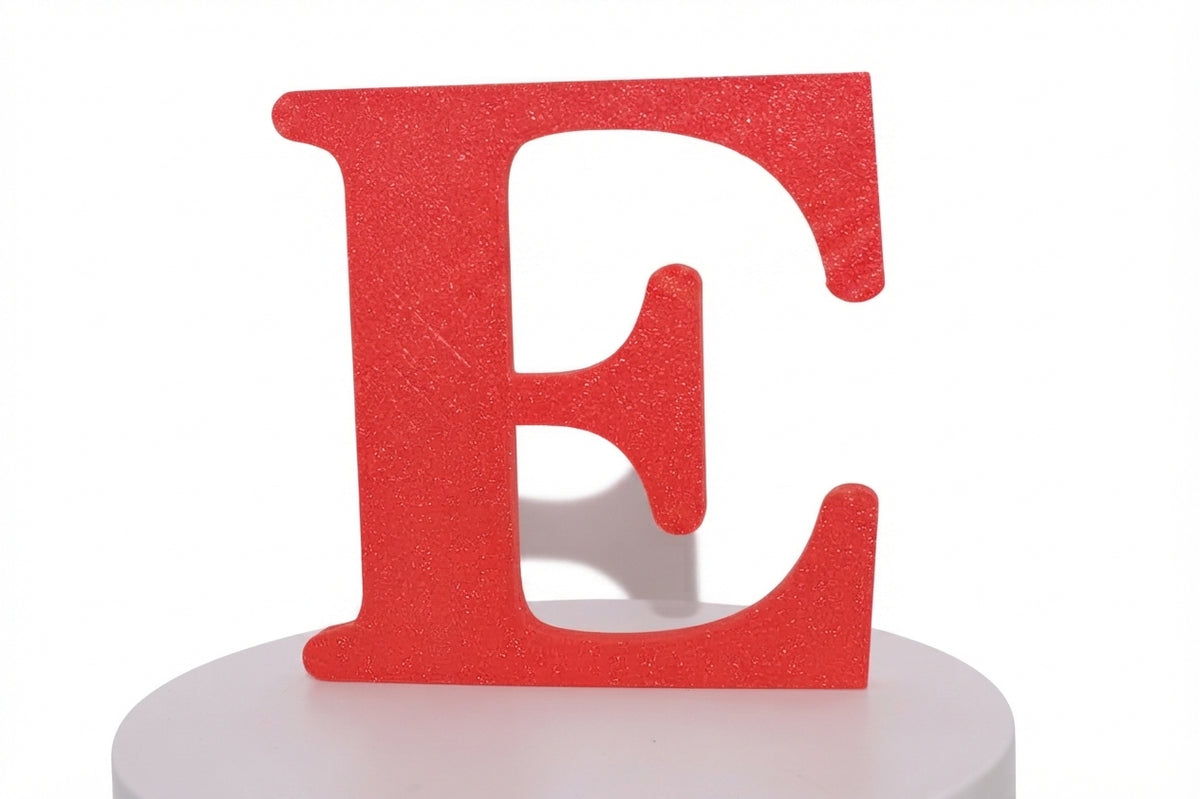 Red E large prop displayed on a round white pedestal, front view.