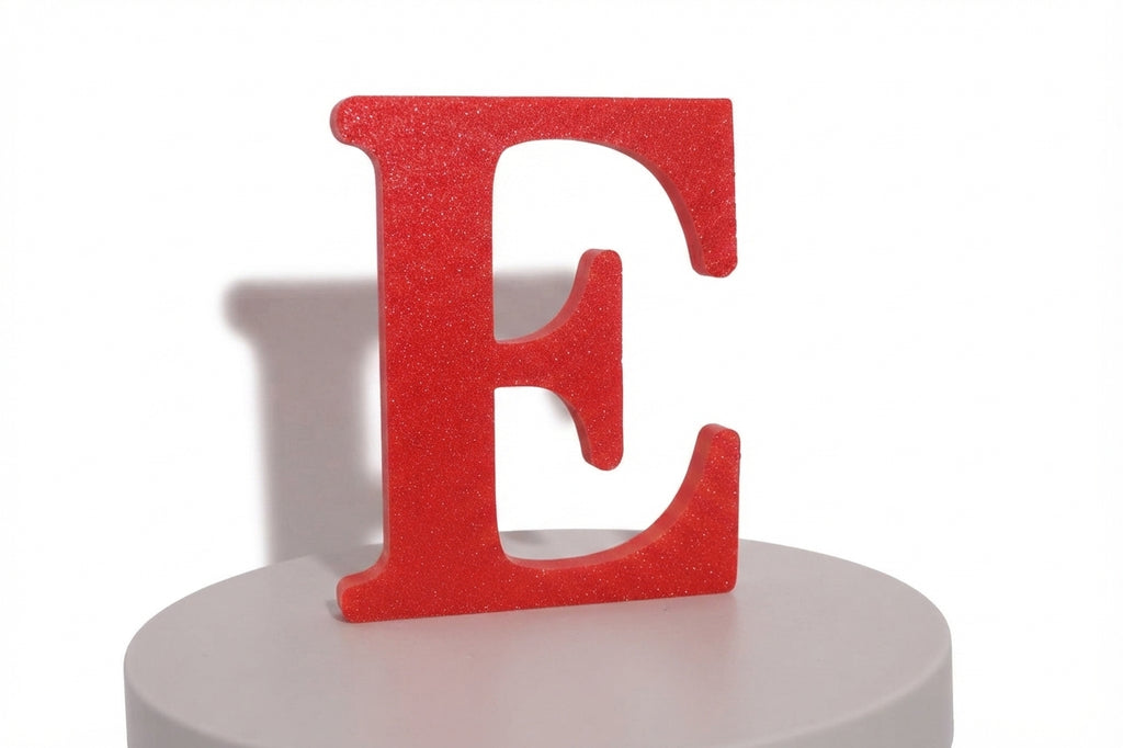 Red E large prop on a round white pedestal, angled view.