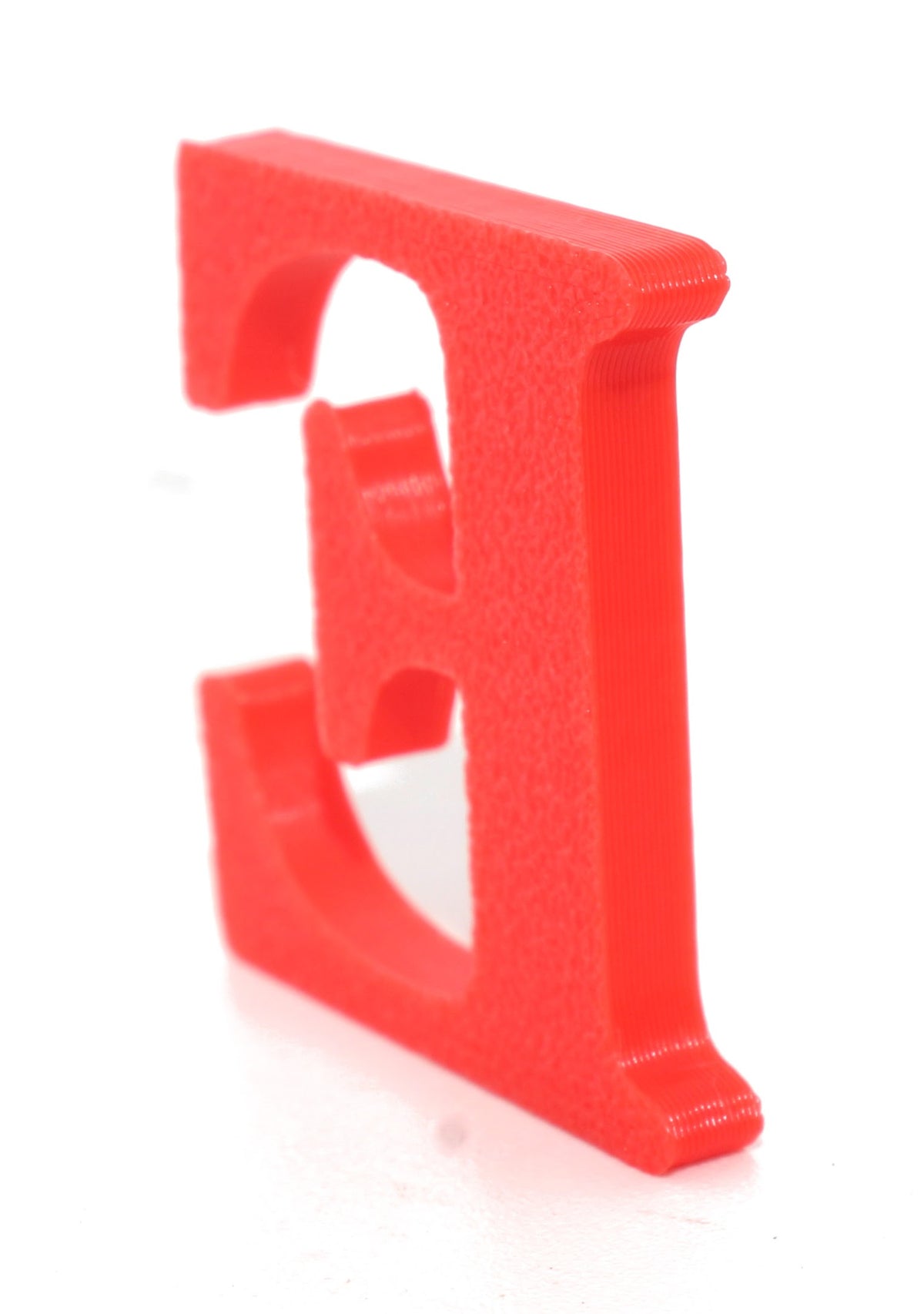 Red E small prop shown from a side angle on a white background.