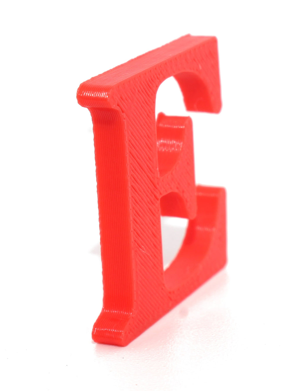 Red E small prop showing the 3D-printed layer texture, front view.
