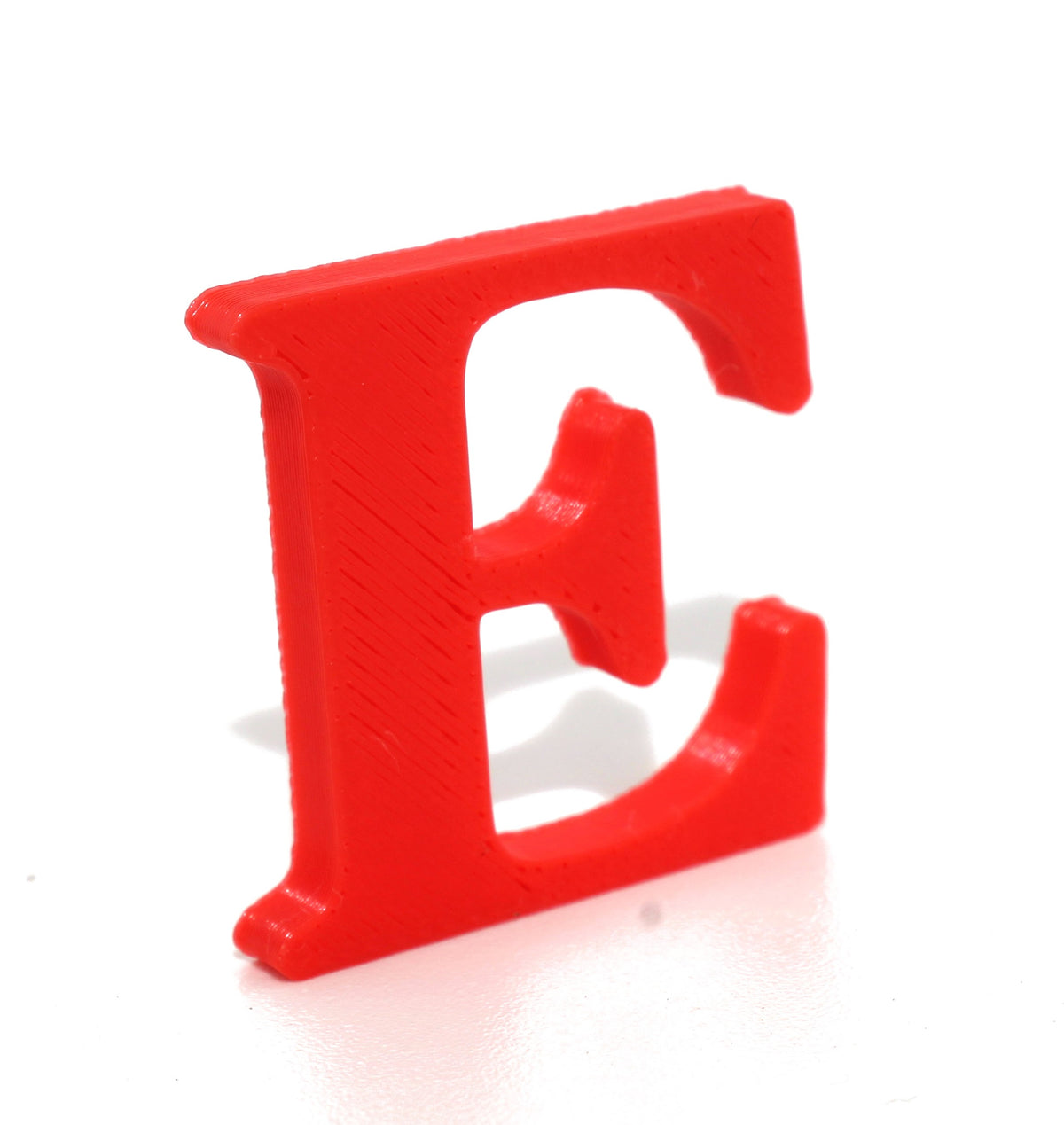Red E small prop with a soft shadow on a clean white background.