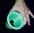Green Q Family chop cup held open, showing two black balls inside