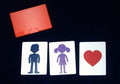 Love Monte cards — boy, girl and heart — with red card case on a dark mat