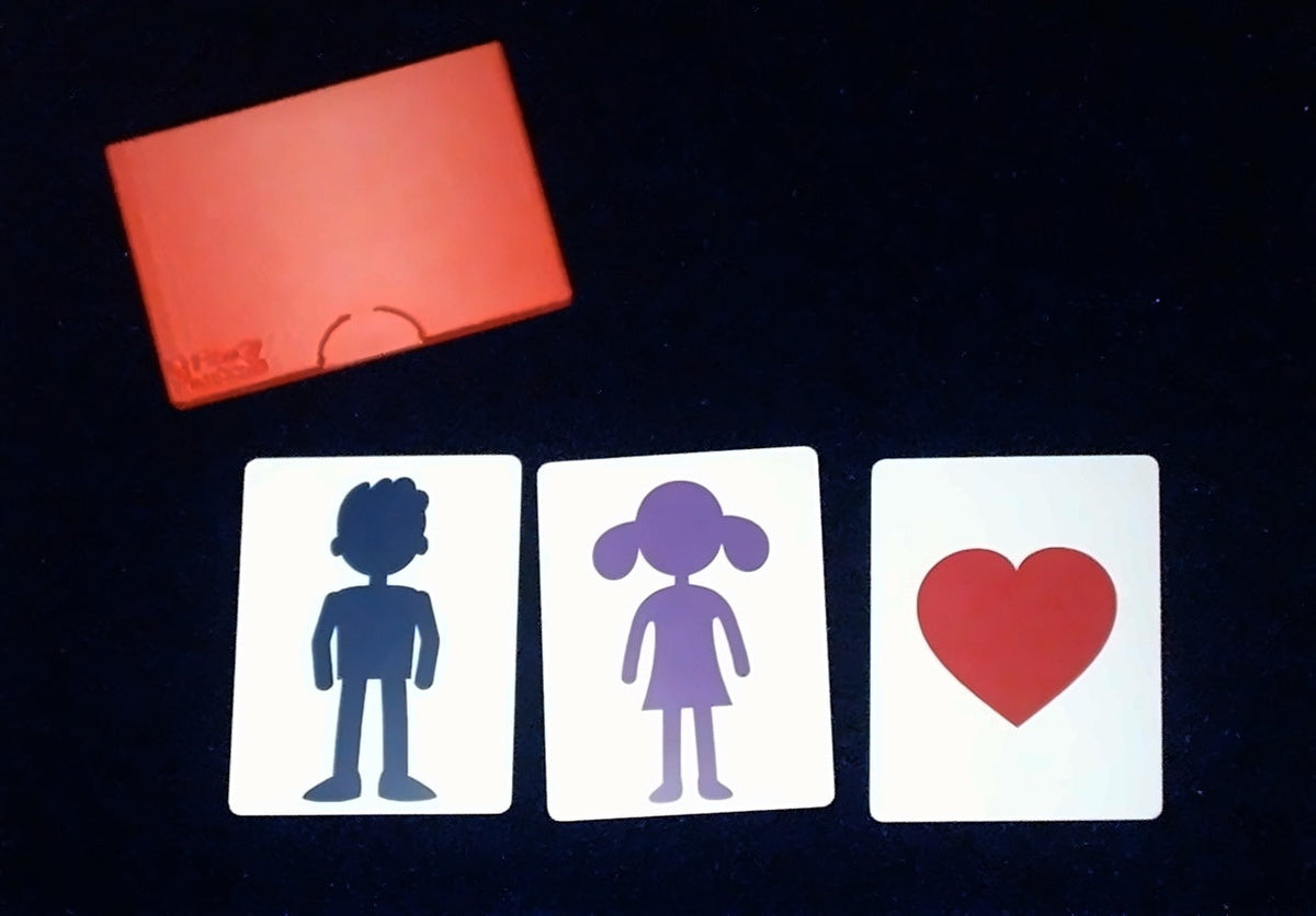 Love Monte cards — boy, girl and heart — with red card case on a dark mat